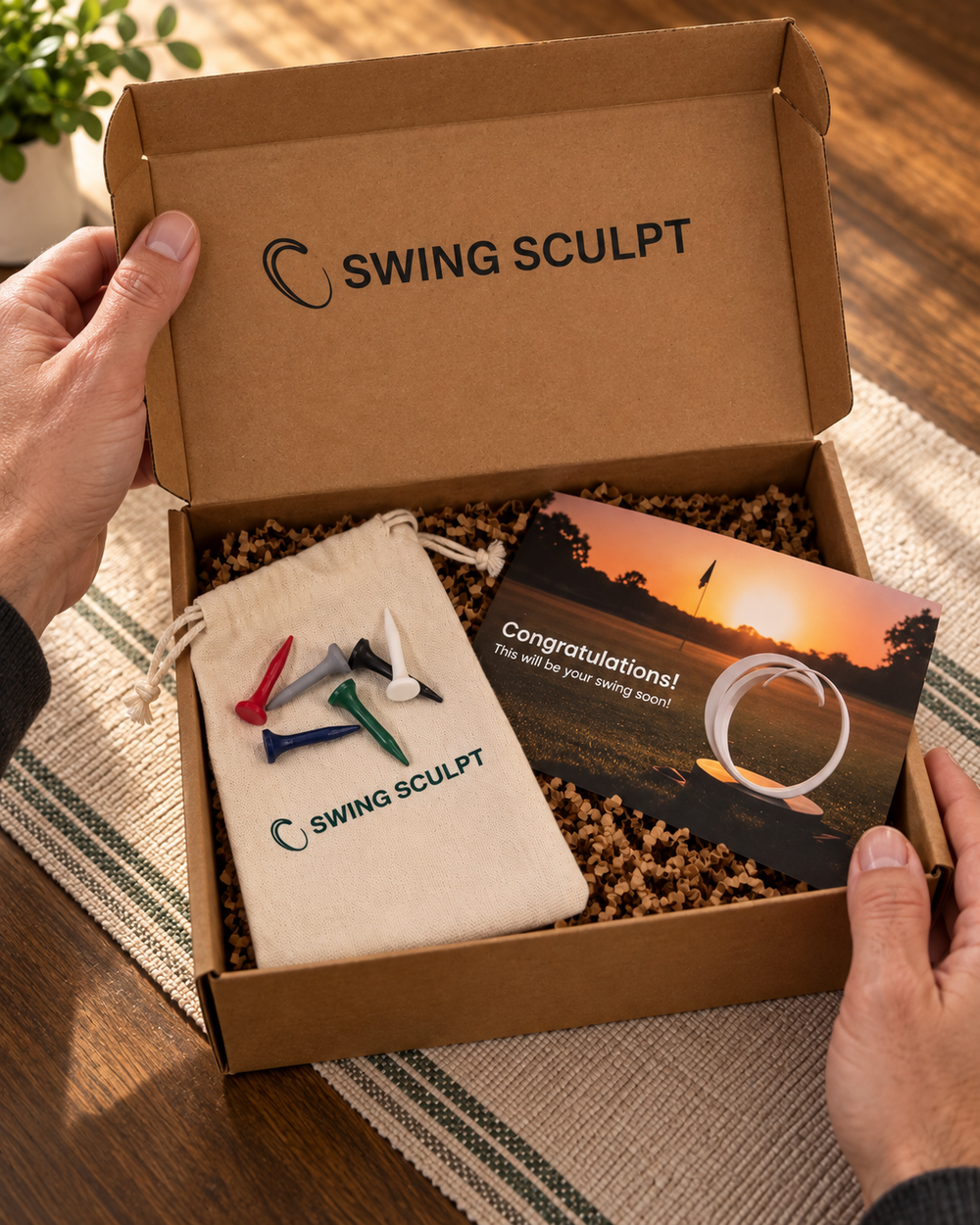 Swing Sculpt gift box with six colored golf tees, a pouch and a QR card